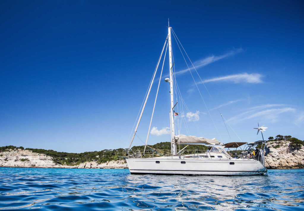 Beautiful bay with sailing boat in Mediterranean sea.