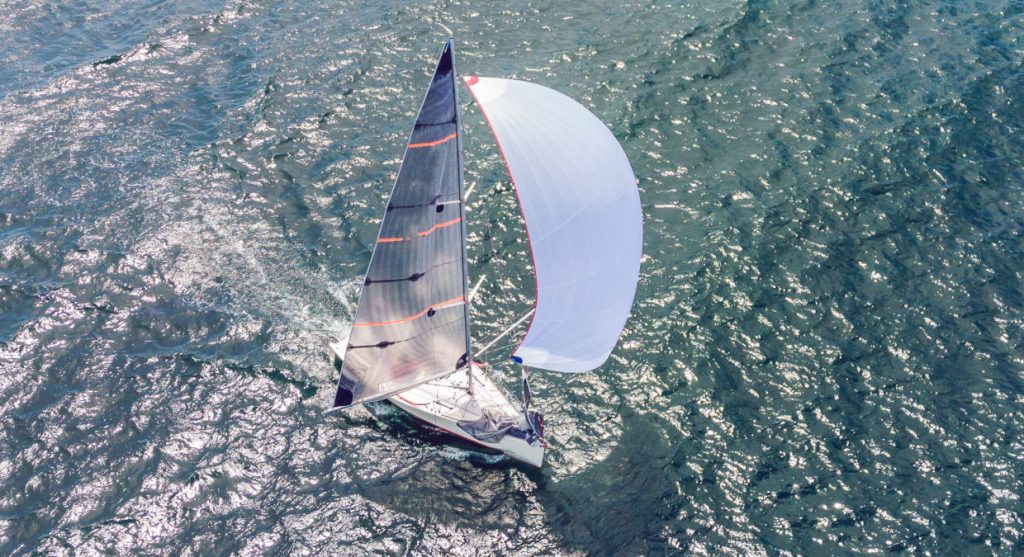 Sailing yacht on a dead run with a mainsail and a symmetric spinnaker